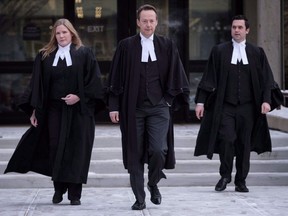 Crown persecutor Doug Taylor, centre, leaves court after Joshua Frank and Jason Klaus were pronounced guilty by a judge in Red Deer, Alta., Wednesday, Jan. 10, 2018. The pair were found guilty of first-degree murder in the shooting deaths of Klaus's parents and sister in a rural home near Castor, Alberta in December 2013.