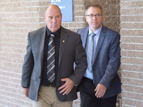 Train driver Thomas Harding, left, leaves the courtroom during a break on the first day of the Lac Megantic trial in Sherbrooke, Que., on Monday, October 2, 2017. Closing arguments at the Lac-Megantic criminal trial enter their third day today as defence lawyers continue to make the case their clients should be found not guilty.