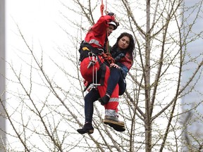 A woman is rescued from a downtown Toronto crane early Wednesday, April 26, 2017.