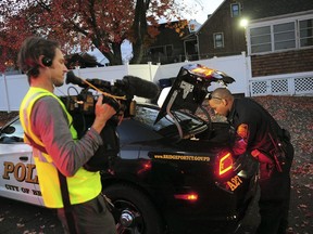 In this Nov. 3, 2016 photo, a crew from the television program "Live PD," a reality show by the A&E Network, records an officer from the Bridgeport Police Department while on patrol in Bridgeport, Conn. Some law enforcement agencies, including the Bridgeport Police, have ended their agreements to be on the show after local government leaders concluded the national spotlight on criminal activity overshadowed the positive things happening in their hometowns.