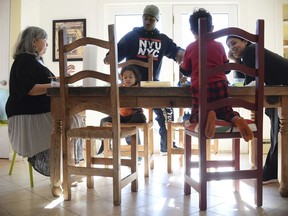 In this Friday, Jan. 26, 2018 photo, artist and author Maybeth Morales, left, leads a home school art class for her grandchildren as her daughter Chemay Morales-James, right, and son-in-law Shane, center, watch in Watertown, Conn. Reports that 13 malnourished siblings allegedly held captive by their parents were home-schooled has others who educate their children at home bracing for calls for more oversight of the practice, a reaction they say would unfairly punish families.