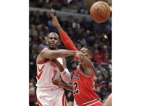 Houston Rockets' Chris Paul (3) passes the ball as Chicago Bulls' Kris Dunn defends during the first half of an NBA basketball game Monday, Jan. 8, 2018, in Chicago.