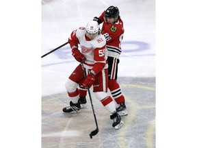 Detroit Red Wings left wing Tyler Bertuzzi (59) controls the puck against Chicago Blackhawks right wing Patrick Kane during the first period of an NHL hockey game Sunday, Jan. 14, 2018, in Chicago.