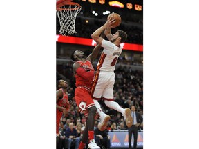 Miami Heat's Tyler Johnson (8) goes up for a shot against Chicago Bulls' Bobby Portis (5) during the first half of an NBA basketball game Monday, Jan. 15, 2018, in Chicago.