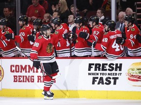 Chicago Blackhawks right wing Patrick Kane (88) celebrates with teammates after scoring against the New York Islanders during the first period of an NHL hockey game Saturday, Jan. 20, 2018, in Chicago.