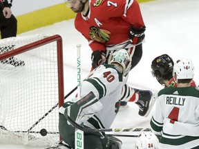 Chicago Blackhawks' Brent Seabrook (7) watches his shot score past Minnesota Wild goaltender Devan Dubnyk (40) during the first period of an NHL hockey game Wednesday, Jan. 10, 2018, in Chicago.