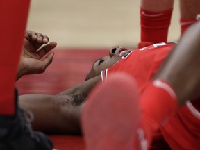 Chicago Bulls' Kris Dunn lays on the floor after hitting his face on the floor at the end of a dunk during the second half of an NBA basketball game against the Golden State Warriors Wednesday, Jan. 17, 2018, in Chicago. The Warriors won 119-112.
