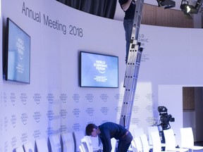 Workers are busy with preparations for the 48th annual meeting of the World Economic Forum, WEF, in Davos, Switzerland, Sunday, Jan. 21, 2018. The meeting brings together entrepreneurs, scientists, chief executives and political leaders from Jan. 23 to 26.
