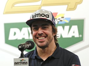 Fernando Alonso, of Spain, answers questions at a news conference about the IMSA 24-hour auto race at Daytona International Speedway, Thursday, Jan. 25, 2018, in Daytona Beach, Fla.