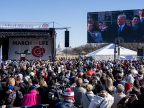 President Donald Trump speaks via a live feed to anti-abortion activists as they rally on the National Mall in Washington, Friday, Jan. 19, 2018, during the annual March for Life. Thousands of anti-abortion demonstrators gather in Washington for an annual march to protest the Supreme Court's landmark 1973 decision that declared a constitutional right to abortion.