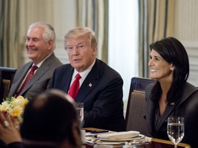 President Donald Trump, accompanied by Secretary of State Rex Tillerson, left, and U.S. Ambassador to the UN Nikki Haley, right, has lunch with the United Nations Security Council in the State Dining Room at the White House, Monday, Jan. 29, 2018, in Washington.