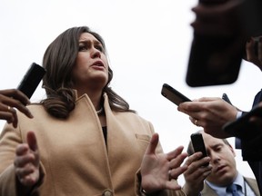 White House press secretary Sarah Huckabee Sanders talks to media outside the White House in Washington during the government shutdown, Monday, Jan. 22, 2018.