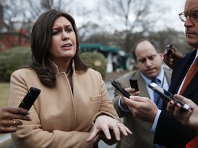 White House press secretary Sarah Huckabee Sanders talks to media outside the White House in Washington during a government shutdown , Monday, Jan. 22, 2018.