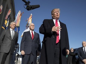 President Donald Trump, joined by Defense Secretary Jim Mattis, left, Vice President Mike Pence, second from left, and White House Chief of Staff John Kelly, right, speaks to the media as he arrives at the Pentagon, Thursday, Jan. 18, 2018.