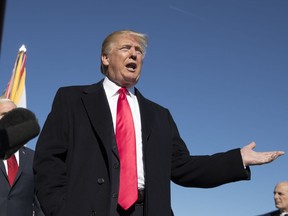 President Donald Trump speaks to the media at the Pentagon, Thursday, Jan. 18, 2018. At right is White House Chief of Staff John Kelly.