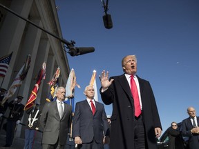 President Donald Trump, joined by Defense Secretary Jim Mattis, left, Vice President Mike Pence, second from left, and White House Chief of Staff John Kelly, right, speaks to the media as he arrives at the Pentagon, Thursday, Jan. 18, 2018.