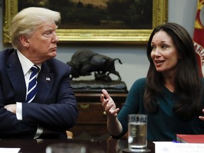 President Donald Trump, looks to Brooke Rollins, President and CEO of the Texas Public Policy Foundation, as she speaks during a prison reform roundtable in the Roosevelt Room of the Washington, Thursday, Jan. 11, 2018.