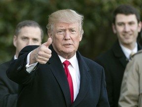President Donald Trump gives the thumbs-up as he arrives on Marine One at the White House in Washington, Thursday, Jan. 18, 2018, as he returns from Pittsburgh.