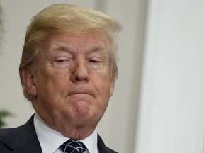 President Donald Trump listens as Secretary of Housing and Urban Development Ben Carson speaks during an event to honor Dr. Martin Luther King Jr., in the Roosevelt Room of the White House, Friday, Jan. 12, 2018, in Washington.