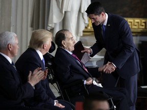 President Donald Trump and Vice President Mike Pence watch as House Speaker Paul Ryan of Wis., greets former Sen. Bob Dole during a Congressional Gold Medal ceremony honoring Dole on Capitol Hill, Wednesday, Jan. 17, 2018, in Washington.