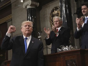 President Donald Trump gestures as he finishes his first State of the Union address in the House chamber of the U.S. Capitol to a joint session of Congress Tuesday, Jan. 30, 2018 in Washington, as Vice President Mike Pence and House Speaker Paul Ryan applaud.