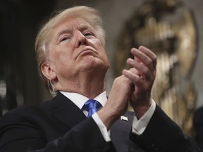 President Donald Trump applauds as he finishes his first State of the Union address in the House chamber of the U.S. Capitol to a joint session of Congress Tuesday, Jan. 30, 2018 in Washington.
