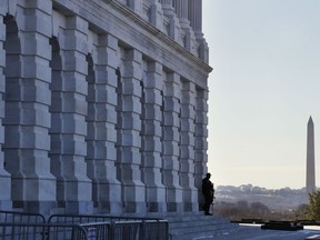 As a bitterly-divided Congress hurtles toward a government shutdown this weekend, a Capitol Police officer guards his post, Friday, Jan. 19, 2018, on Capitol Hill in Washington.