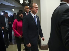 Rep. Adam Schiff, D- Calif., center, ranking member of the House Intelligence Committee, walks back to the meeting room after speaking to members of the media, Monday, Jan. 29, 2018 on Capitol Hill in Washington. Also with Schiff are Rep. Terri Sewell, D-Ala., left, and Rep. Andre Carson, D-Ind. Brushing aside opposition from the Department of Justice, Republicans on the House intelligence committee have voted to release a classified memo that purports to show improper use of surveillance by the FBI and Justice Department in the Russia investigation.