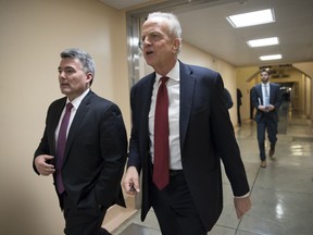 Sen. Cory Gardner, R-Colo., left, and Sen. Jerry Moran, R-Kan., return to their offices on Capitol Hill as Congress moves closer to the deadline to avoid a government shutdown, in Washington, Thursday, Jan. 18, 2018.