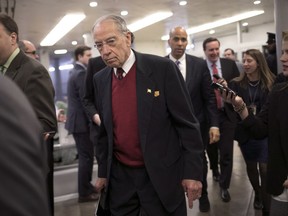 Senate Judiciary Committee Chairman Chuck Grassley, R-Iowa, and other senators arrive to vote on the confirmation of Samuel Brownback, governor of Kansas and a former U.S. senator, to become the ambassador-at-large for international religious freedom, at the Capitol in Washington, Wednesday, Jan. 24, 2018.