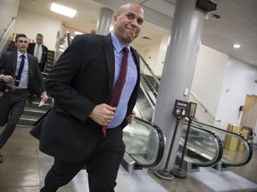 Sen. Cory Booker, D-N.J., runs to catch a subway car as he returns to his office on Capitol Hill as Congress moves closer to the deadline to avoid a government shutdown, in Washington, Thursday, Jan. 18, 2018.