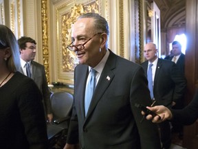 Senate Minority Leader Chuck Schumer, D-N.Y., heads to the chamber with fellow Democrats for a procedural vote aimed at reopening the government, at the Capitol in Washington, Monday, Jan. 22, 2018.