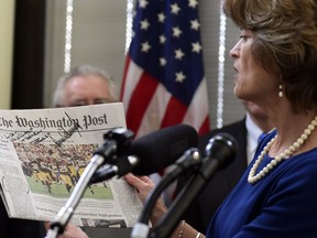 Sen. Lisa Murkowski, R-Alaska, holds up a copy of a news paper with a note from President Donald Trump during an event in her office on Capitol Hill in Washington, Monday, Jan. 22, 2018. Murkowski was joined by other Alaskan officials regarding the Interior Department's decision to the construction of a road through a national wildlife refuge in Alaska.The road would connect the communities of King Cove and Cold Bay, which has an all-weather airport needed for emergency medical flights.