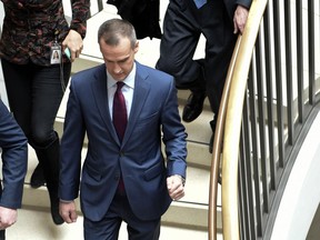 President Donald Trump's former campaign manager Corey Lewandowski, center, arrives on Capitol Hill in Washington, Wednesday, Jan. 17, 2018, where his is expected to be interviewed by the House Intelligence Committee regarding the Russia probe.