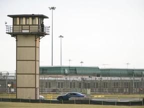 FILE - In this Feb. 1, 2017, file photo, a prison guard stands on a tower during a hostage situation at James T. Vaughn Correctional Center in Smyrna, Del. An independent review ordered by Delaware Gov. John Carney after the riot at Vaughn Correctional Center includes scores of recommendations for reforms. But officials say many of those reforms depend on adequate staffing, which remains an elusive goal.