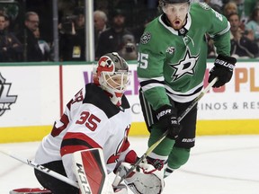 New Jersey Devils goaltender Cory Schneider (35) defends the goal against Dallas Stars right wing Brett Ritchie (25) during the first period of an NHL hockey game in Dallas, Thursday, Jan. 4, 2018.