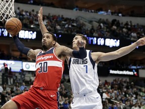Washington Wizards forward Mike Scott (30) goes up for a shot as Dallas Mavericks' Dwight Powell (7) defends in the second half of an NBA basketball game, Monday, Jan. 22, 2018, in Dallas.