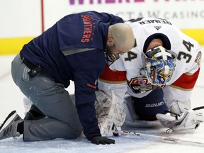 Florida Panthers staff help goaltender James Reimer after Reimer suffered an apparent injury in the opening minutes of the team's NHL hockey game against the Dallas Stars on Tuesday, Jan. 23, 2018, in Dallas.