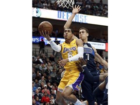 Los Angeles Lakers guard Jordan Clarkson (6) goes up for a shot after getting past Dallas Mavericks forward Dwight Powell (7) in the first half of an NBA basketball game, Saturday, Jan. 13, 2018, in Dallas.