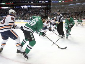 Edmonton Oilers center Ryan Nugent-Hopkins (93), Dallas Stars defenseman Stephen Johns (28), Oilers left wing Jujhar Khaira (16) and Stars center Jason Spezza (90) chase after the puck during the first period of an NHL hockey game in Dallas, Saturday, Jan. 6, 2018.