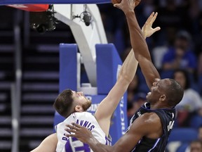 Sacramento Kings' Georgios Papagiannis, left, defends as Orlando Magic's Bismack Biyombo, right, tries to get to the basket during the first half of an NBA basketball game, Tuesday, Jan. 23, 2018, in Orlando, Fla.