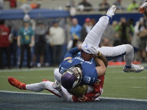 NFC wide receiver Adam Thielen (19), of the Minnesota Vikings, scores a touchdown as AFC defensive back A.J. Buoy (21), of the Jacksonville Jaguars defends, during the first half of the NFL Pro Bowl football game, Sunday, Jan. 28, 2018, in Orlando, Fla.