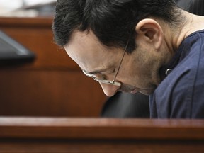 Larry Nassar hangs his head as former gymnast Amanda Thomashow gives her victim statement Tuesday, Jan. 23, 2018,  in Ingham County Circuit Court in Lansing, Mich.