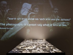 In this Wednesday, Jan. 24, 2018, photo, a part of the "Flashes of Memory" exhibition of the photos from the Holocaust is seen at at the Yad Vashem Holocaust memorial in Jerusalem. Israel's Yad Vashem Holocaust memorial's latest exhibition explores the power of photography during World War II.