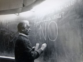 In this 1992 photo, Nicanor Parra writes on the blackboard as he teaches a class at an engineering school in Santiago, Chile. His messages reads in Spanish "Back to democracy for what. So the movie repeats itself? No." Parra, a Chilean physicist, mathematician and self-described "anti-poet" whose eccentric writings won him a leading place in Latin American literature, died Tuesday, Jan. 23, 2018. He was 103.