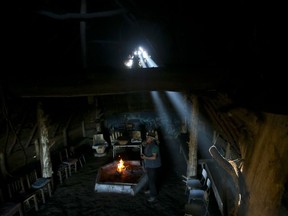 In this Jan. 7, 2018 photo, Mauricio Painefil readies a traditional indigenous home known as a "ruca" for tourists, in the Mapuche community Llaguepulli in Temuco, Chile. The Mapuche are successfully introducing ethno-turismo, sharing their ancestral traditions and culture.