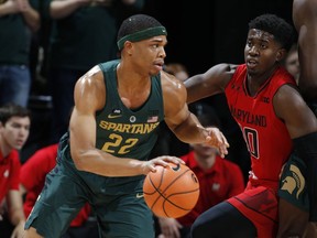 Michigan State's Miles Bridges, left, drives against Maryland's Darryl Morsell during the first half of an NCAA college basketball game Thursday, Jan. 4, 2018, in East Lansing, Mich.