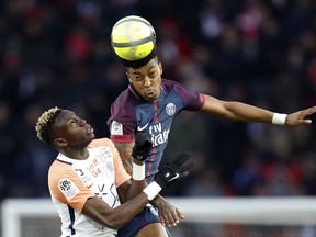 PSG's Presnel Kimpembe, right, and Montpellier's Salomon Sambia jump for the ball during their French League One soccer match between Paris Saint Germain and Montpellier at the Parc des Princes stadium in Paris, Saturday, Jan. 27, 2018.