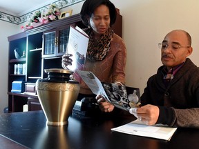 Pastor Timothy Hutton, of the Second Baptist Church in Mount Holly, and a licensed funeral director, and his wife Dawn, look over cremation urns in Burlington, N.J.