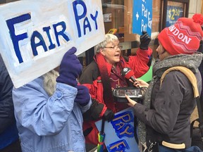 Protesters outside a Tim Hortons restaurant in London, Ont., call on the owners to "Pay Fair" following Ontario's minimum wage hike on Jan. 1, 2018.